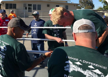 a group of volunteers working on a gate