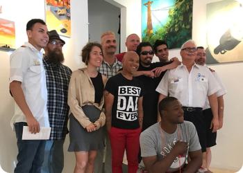 a group of people smiling with a person in front wearing a shirt that says "Best Day Ever"